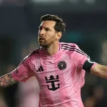 Lionel Messi in a pink Inter Miami jersey looking focused during a match against Atletico San Luis.