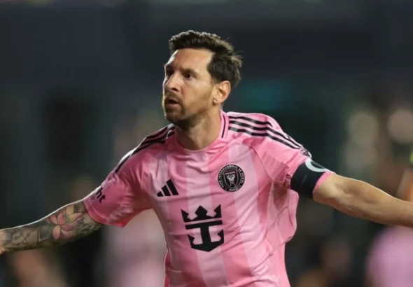 Lionel Messi in a pink Inter Miami jersey looking focused during a match against Atletico San Luis.