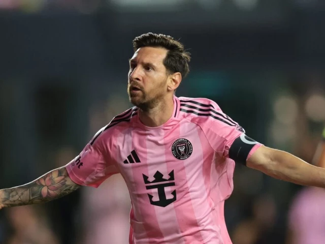 Lionel Messi in a pink Inter Miami jersey looking focused during a match against Atletico San Luis.