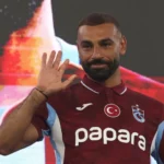 Trabzonspor's new signing Mohamed Salah waving to the fans while wearing the team's burgundy kit.