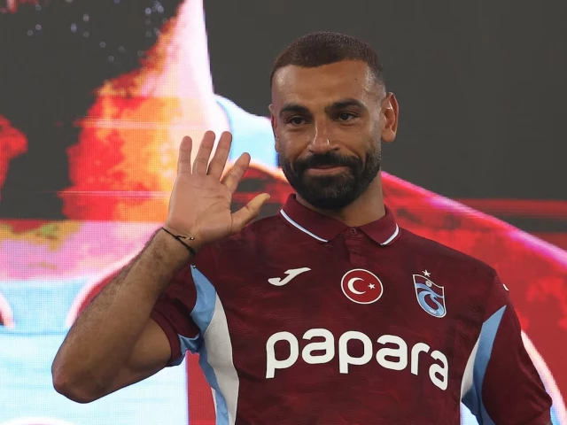 Trabzonspor's new signing Mohamed Salah waving to the fans while wearing the team's burgundy kit.